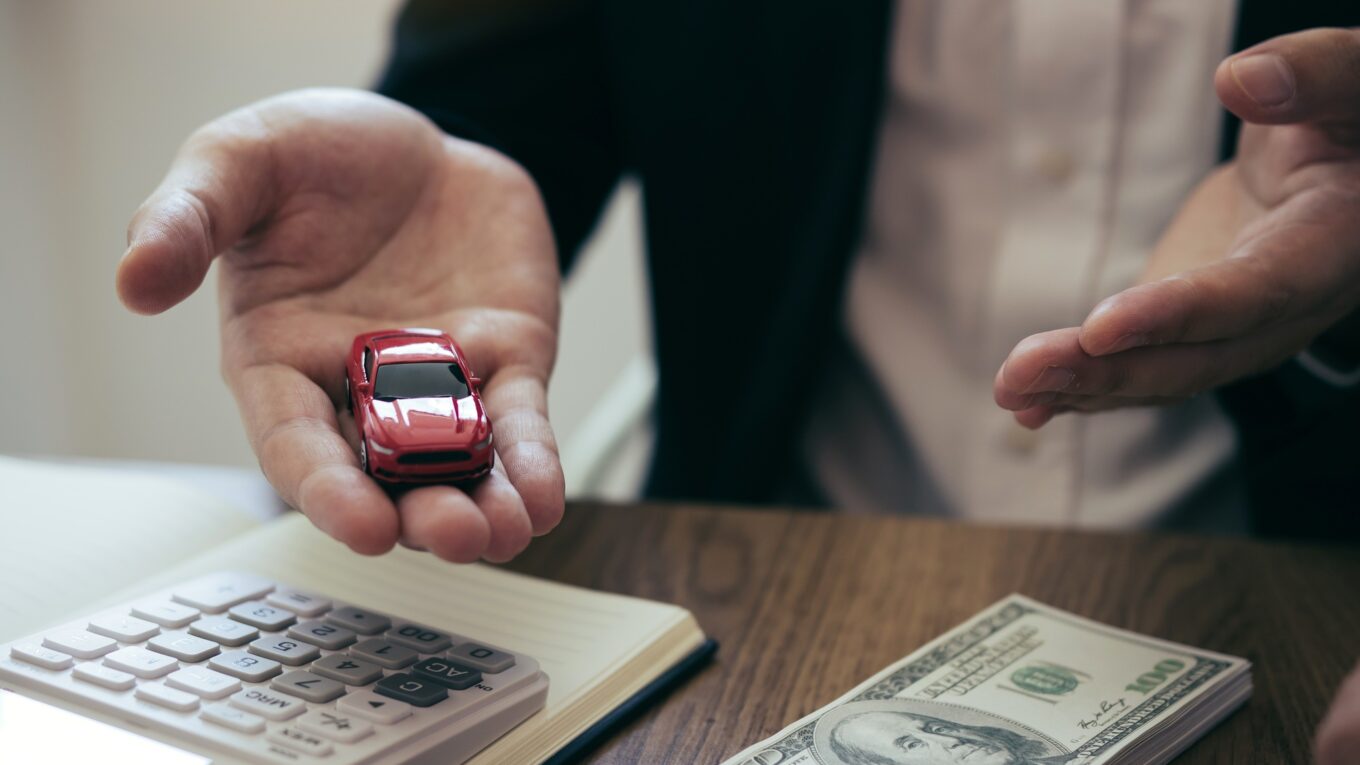 Sales car agent explains about the contract to buy a new car to the customer