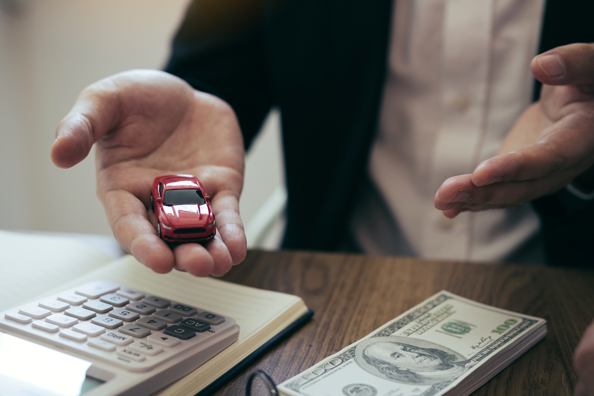 Sales car agent explains about the contract to buy a new car to the customer