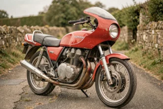 Honda CB Boldor 900 garée sur une route rurale, vue trois quarts avant mettant en valeur le demi-carénage et l'échappement chromé